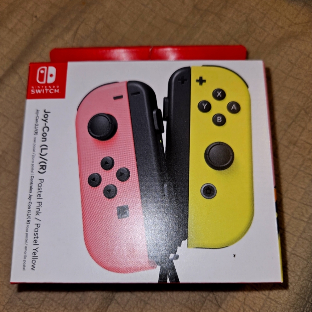Nintendo joy con controllers pink and yellow